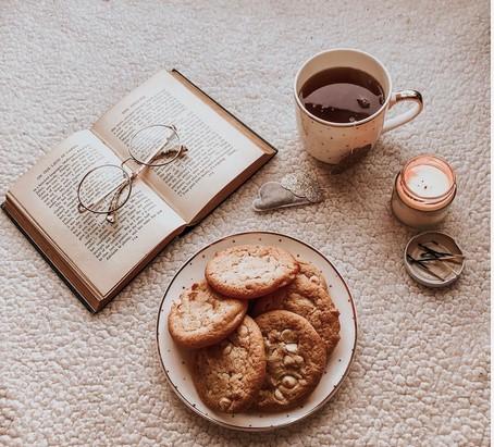 Baked Goods Next to a book with coffee